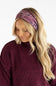 A woman with long blonde hair wearing a mauve paisley bandana headband and a matching mauve knit sweater, shown against a plain white background.