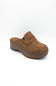 A single brown suede mule slipper with a chunky platform wedge heel, shown from a three-quarters angle on a white background.