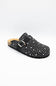 A single black clog-style mule shoe with white polka dots, a black strap with a silver buckle, and a cork-look midsole, shown on a plain white background.