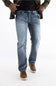 A person wearing light-wash blue denim jeans with a black shirt and olive green jacket, standing against a plain white studio background.
