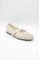 A single cream-colored woven mesh Mary Jane flat shoe with a small gold buckle, shown on a light gray studio background.