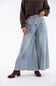 A model wearing light-wash wide-leg denim jeans, a dark brown knit sweater, and brown suede ankle boots, standing against a plain white studio background.