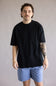 Industrie Del Sur T-Shirt for Men in Black; Man wearing a black t-shirt and blue shorts against a plain background