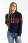 A woman modeling a colorblock hoodie with navy blue, burgundy, and rust orange horizontal stripes, paired with blue jeans, against a plain white studio background.