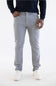 A person wearing light gray slim-fit jeans, a dark navy long-sleeve top, and white sneakers, standing against a plain white studio background.