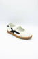 A single white slip-on shoe with a black side stripe and a brown gum sole, photographed on a clean white background.