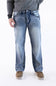 Front view of a male model wearing True Luck Mac Loose Straight medium-wash jeans with light fading and whiskering, a grey long-sleeve sweater, and brown casual shoes against a plain white background.