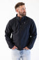 A man wearing a dark navy blue zip-up jacket with a small white dog logo on the left chest, paired with light blue jeans, photographed against a plain white background.
