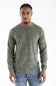 Front studio portrait of a model wearing the long-sleeve Marsh Wear Surfside Waffle Knit Shirt in Fossil Foxhole Camo green, featuring a crew neck with a cross-stitch detail and waffle-textured fabric, styled with blue jeans.