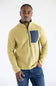 A man wearing a yellow textured quarter-zip fleece pullover with a dark gray chest pocket and blue jeans, photographed against a plain white studio background.