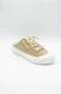 A single low-top slip-on sneaker in beige canvas with a white rubber sole, shown from the side on a light gray background.