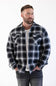 man with his hands in his front pockets, modling a sherpa lined flannel shacket