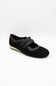 Black shoe with velcro straps on a white background