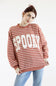 Women wearing dusty mauve sweatshirt with white horizontal stripes, SPOOKY screen printed on front and blue denim jeans on a basic background