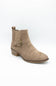 A taupe suede ankle boot with a side buckle strap and low block heel, shown from a three-quarters angle on a white background.