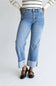 Woman wearing striped shirt with straight leg jeans and cuffed leg.
