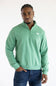 A man wearing the The North Face Evolution Simple Dome ¼ Zip Neck for Men in Dimmed Algae Green with a white The North Face Logo on the upper left chest.