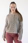 A woman modeling a cropped, long-sleeve knit cardigan with horizontal stripes in beige, featuring a button-down front. She is wearing dusty rose pants against a plain white studio background.