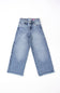 girls jeans laid on a plain white background