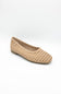 A single woven flat shoe in a light tan or beige color, shown from a three-quarters angle on a white studio background.