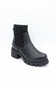 A single black ankle boot with a ribbed elastic side panel and a chunky lug sole, photographed on a clean white background.