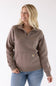 Front view of a stone brown Carhartt quarter-zip sweatshirt featuring a mock-neck collar and a front kangaroo pocket with a small logo patch, worn with blue jeans.