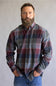 Button down collared flannel shirt in long sleeves, on a blue and red color scheme