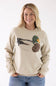 Model wearing the Mallard Duck Sweatshirt for Women in Cream, featuring a crew neckline, long sleeves, and a detailed patch-stitch duck graphic on the front.