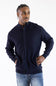 Man wearing a navy mock neck jacket standing against a white background