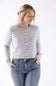 A woman wearing a cream and light blue horizontally striped button-up cardigan sweater with brown buttons, paired with blue jeans, against a plain white studio background.