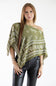 Front view of a model wearing an olive green asymmetric scarf poncho top with a white floral and polka dot print, styled off one shoulder with black leather pants against a plain white background.