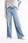 Model posing with a wide leg jean, cropped grey sweater