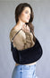 Crescent shaped faux suede shoulder bag with an adjustable buckle detail on strap
