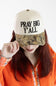 A woman wearing a beige baseball cap with black embroidered text reading 'PRAY BIG Y'ALL' and a camouflage-patterned visor, paired with an orange fleece hoodie against a plain white background.