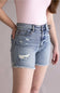 Judy Blue High Rise Distressed Fray Hem Denim Shorts for Women; Denim shorts with distressed details on a neutral background