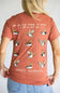 A terracotta-colored short-sleeve t-shirt shown from the back, featuring a graphic print of multiple flying mallards with handwritten-style text above and below. The brand 'simply southern.