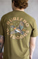 A man viewed from behind wearing an olive green t-shirt with a large graphic on the back. The graphic features the text 'BURLEBO OUTDOORS' in a tan circular font surrounding an illustration of a flying mallard duck with 'Est.