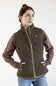 A woman wearing a dark brown quilted vest with brown sleeves and light brown trim, paired with blue jeans, against a plain white background.