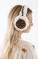 A woman shown from the side wearing fluffy white earmuffs with a leopard print inner panel, against a clean white background.