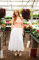 Smocked Waist Tiered Midi Skirt for Women in Off White; Woman standing in a greenhouse with plants and flowers around her