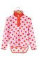 A pink fleece pullover jacket with red polka dots and a red half-zip collar, hanging on a wooden hanger against a white background.