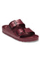 A pair of metallic burgundy double-strap slide sandals with black buckles, shown from a three-quarters angle on a white background.