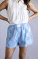 Striped Boxer Shorts for Women in Blue Checkered; Person wearing a white sleeveless top and blue checkered shorts on a plain background