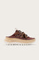 A single low-top sneaker shown in side profile against a light off-white background. The shoe features a dark brown suede upper with a matching brown lace, a thick beige midsole, and a white lug sole.