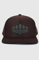 A dark brown snapback cap featuring a green embroidered graphic of pine trees and water on the front panel, set against a light gray background.