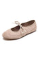 A single women's ballet flat shoe in a light beige suede-like material, featuring a matching beige rope-style bow on the front, set against a plain white background.