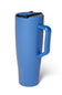 A matte blue insulated travel tumbler with a matching blue handle and lid, featuring a black straw insert and the BRUMATE brand name printed vertically near the base, set against a plain white background.