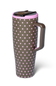 A travel tumbler with a brown body covered in pink polka dots, featuring a matching brown handle, a pink rim, and a dark brown lid with a clear window.