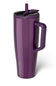 A purple insulated travel tumbler with a handle, lid, and straw, shown on a clean white background. The brand name 'BRUMATE' is vertically printed on the lower left side of the tumbler.