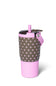 A pink and brown polka-dotted insulated tumbler with a matching pink straw lid and carrying strap, shown on a clean white background.